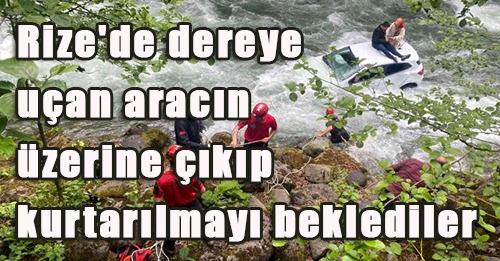 Araçın üstünde kurtarılmayı bekledi